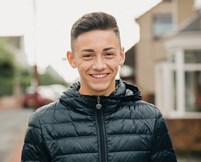 teenage boy smiling in london street